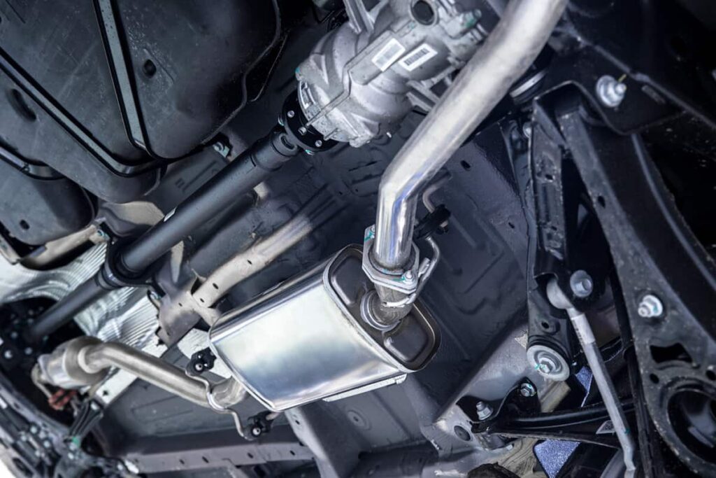 Close-up of a high-performance exhaust system installed on a car for improved airflow and power.